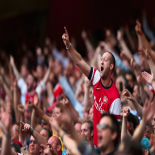 Arsenal fans cheering at the match